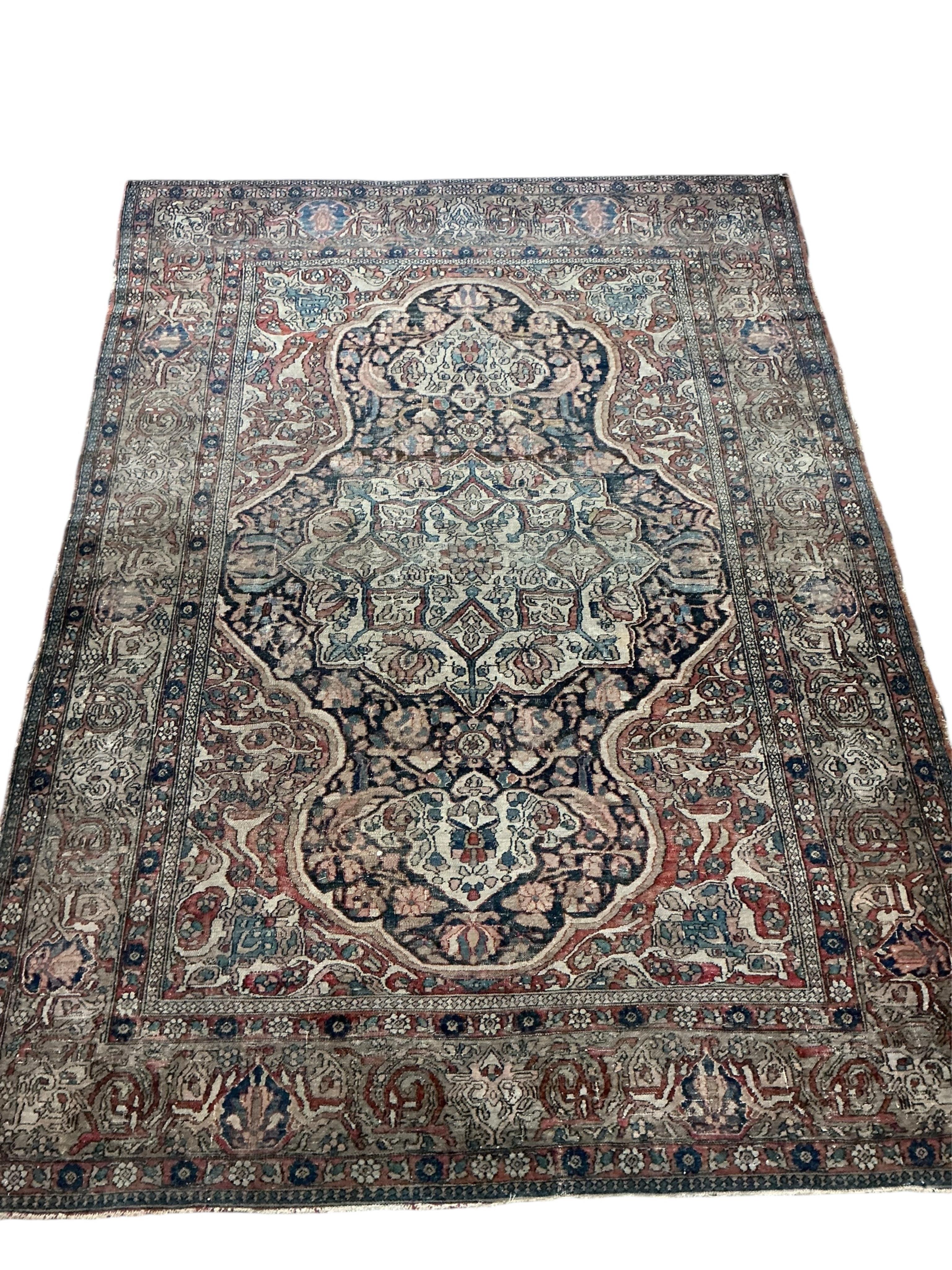 Two antique Isphahan rugs, (worn), larger 194 x 138cm